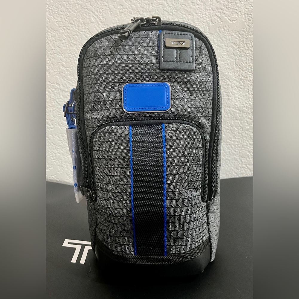 NWT Tumi FIFE Slim Sling Bag Charcoal With Chevron Blue Trim
